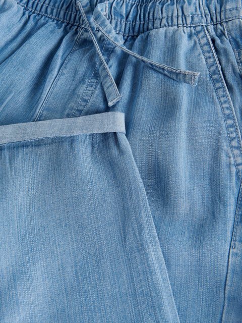 Close-up of blue denim shorts with a focus on the fabric texture.