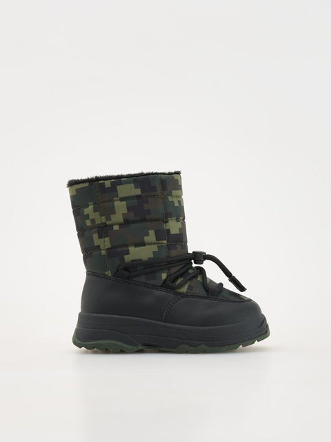 Camouflage-patterned winter boot on a white background