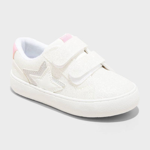 White sneaker with velcro straps on a light gray background