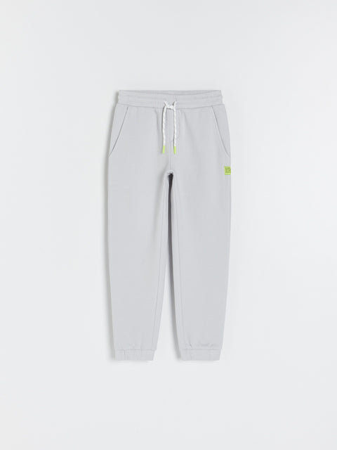 Gray sweatpants with a drawstring on a white background
