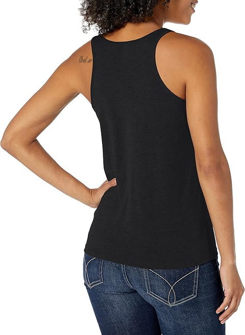 Woman wearing a black tank top and blue jeans on a white background