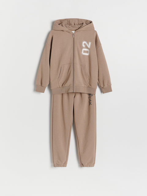 Beige tracksuit with hood and jogger pants on a white background