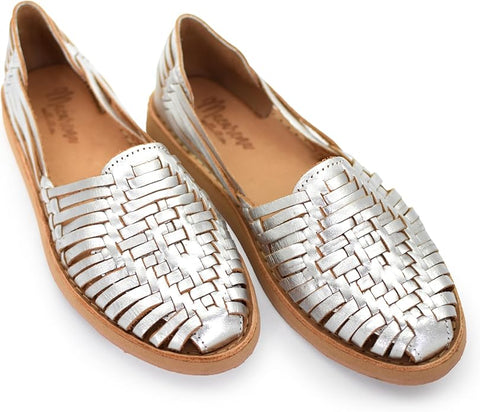 Silver woven flat shoes on a white background