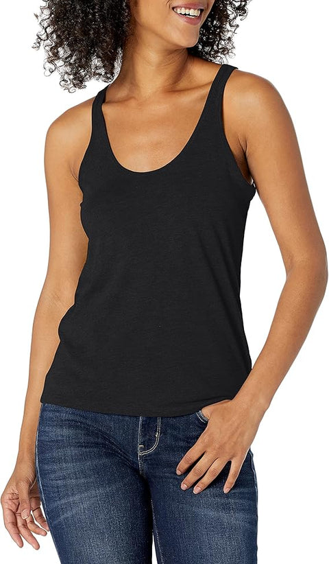 Woman wearing a black tank top and blue jeans on a white background