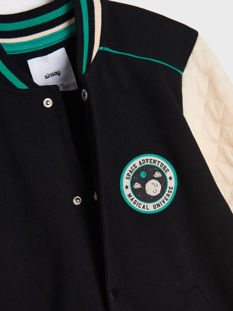 Black jacket with a logo and 'Sasquatch' tag on a white background