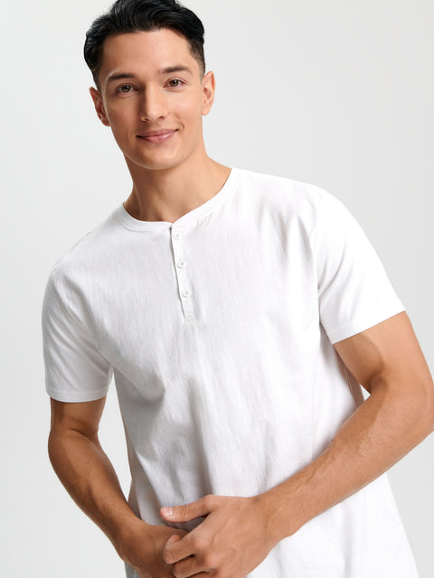 Man wearing a white t-shirt against a plain background