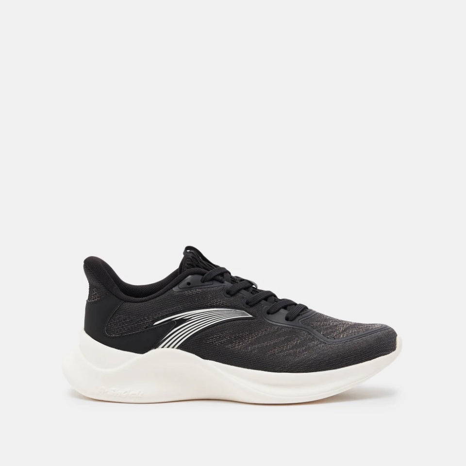 A black athletic sneaker with a textured knit upper, black laces, and a thick white sole, shown from a side profile on a light gray background.