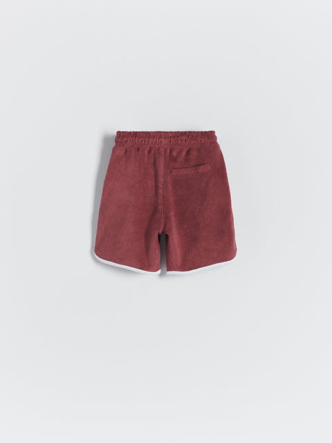 Maroon shorts on a light gray background