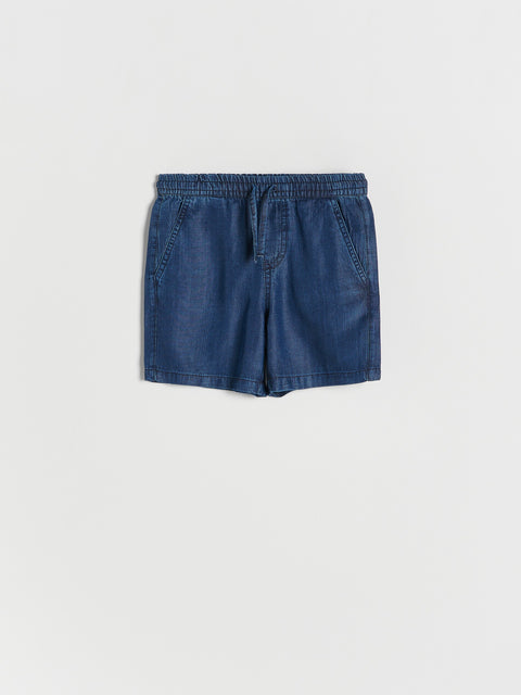 Blue denim shorts on a white background