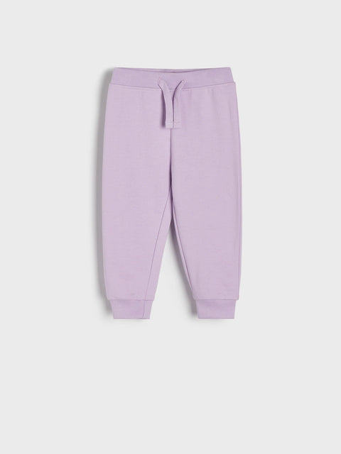 Purple sweatpants on a light gray background
