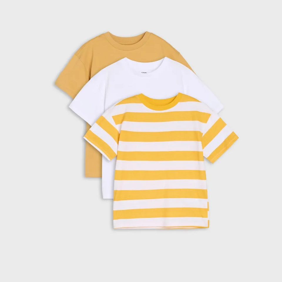 Three short-sleeve kids' t-shirts stacked together on a light gray background. The front shirt is white with yellow horizontal stripes, the middle shirt is solid white, and the back shirt is solid mustard yellow.