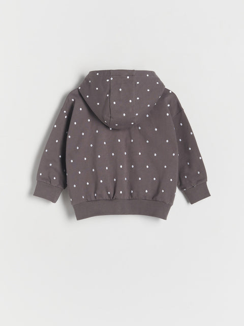 Children's hoodie with white polka dots on a light gray background