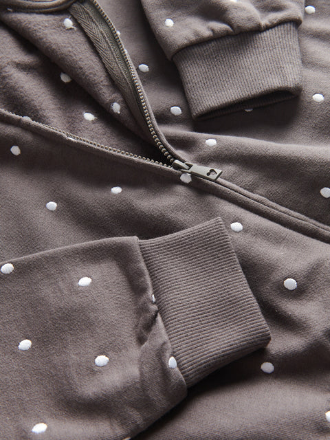 Brown jacket with white polka dots on a matching fabric background