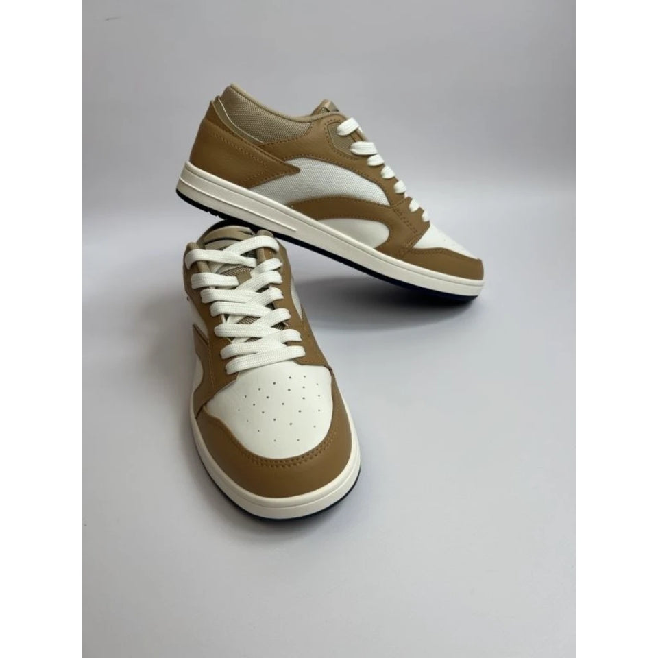A pair of low-top sneakers in tan and white, with one shoe standing upright and the other resting on its side to show the side profile. The shoes feature a tan leather upper with white panels, white laces, and a white midsole.