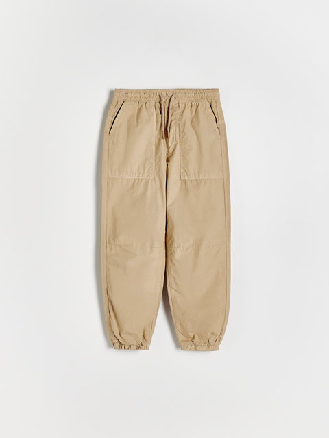 Beige cargo pants on a white background