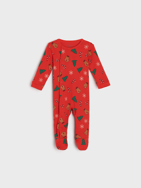 Red baby onesie with Christmas patterns on a white background