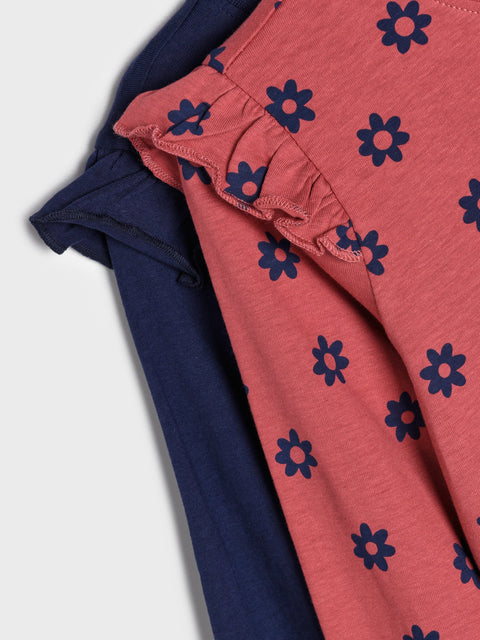 Navy and pink leggings with blue floral patterns on a light gray background