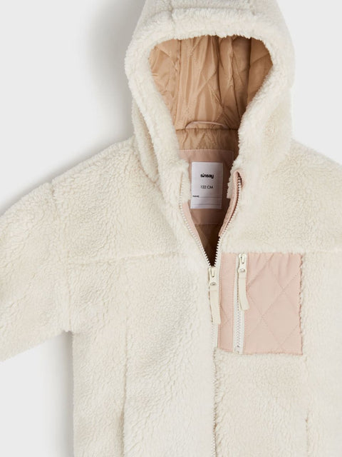 Cream-colored fleece jacket with a brand label on a white background