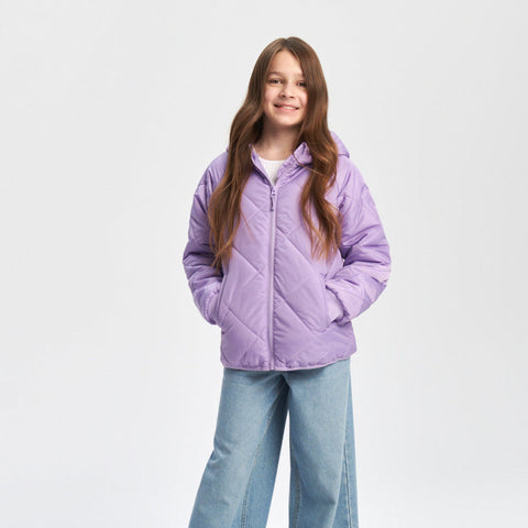 Person wearing a purple puffer jacket and blue jeans on a white background