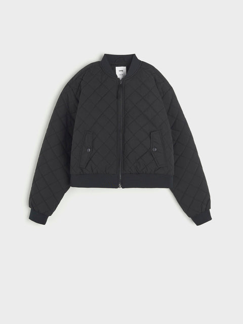 Black quilted jacket on a light gray background