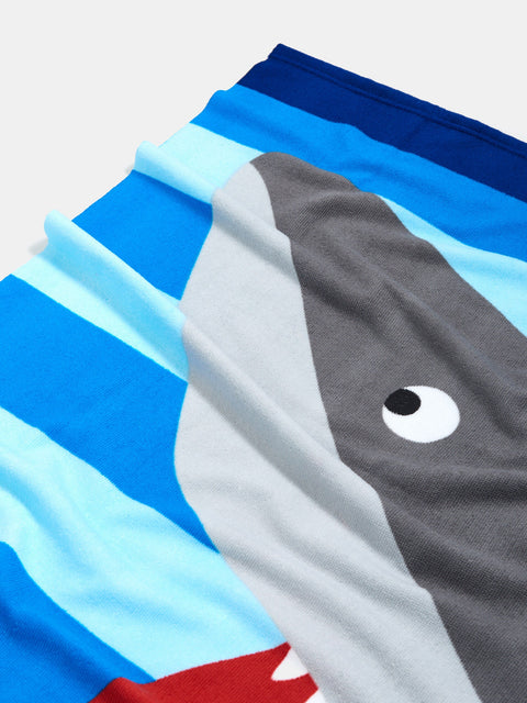 Shark-themed swim shorts with a colorful striped pattern on a white background