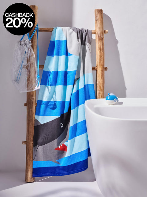 Blue and gray striped towel with cartoon design on a wooden rack next to a white sink.