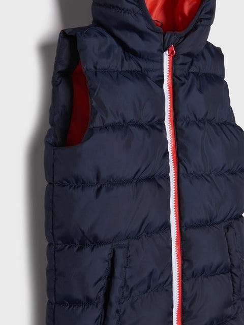 Navy puffer vest with a red interior and zipper on a light gray background