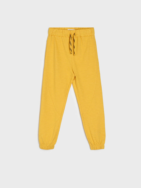 Yellow sweatpants on a light gray background