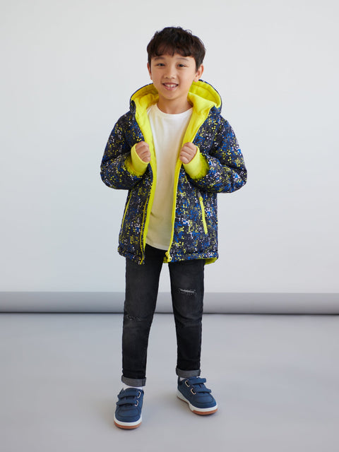 Child wearing a blue and yellow jacket with a white background