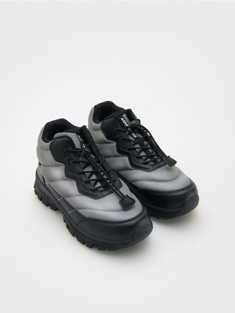 Pair of gray and black sneakers on a white background