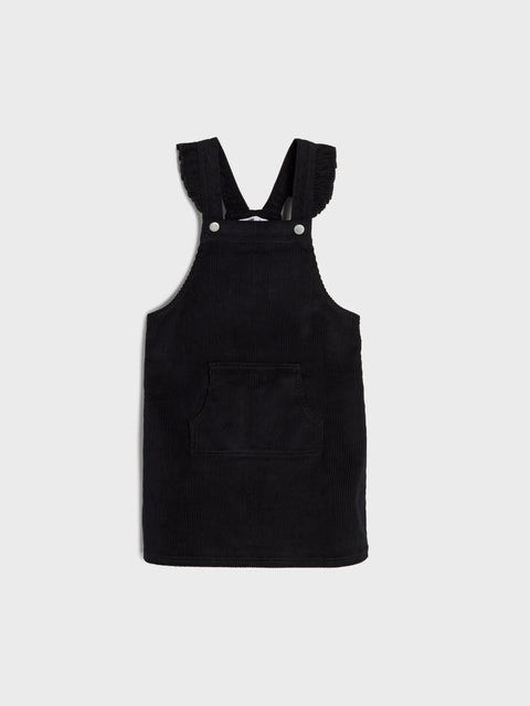Black pinafore dress on a white background