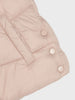 Close-up of a pink quilted jacket with buttons on a white background