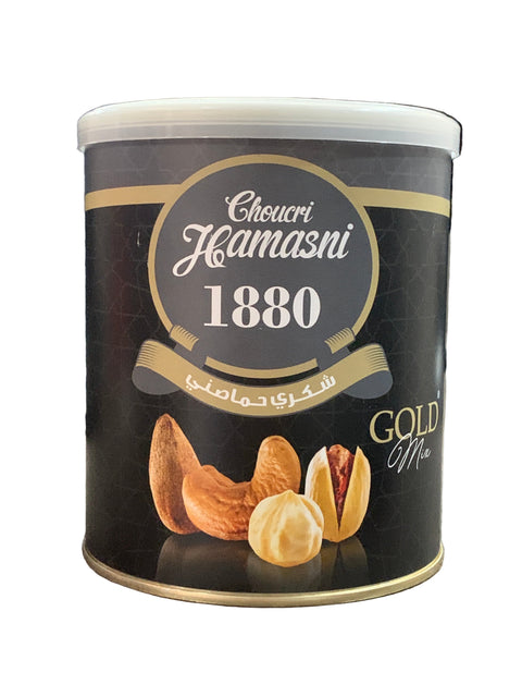 Canister of Ghirardelli Gold Label chocolate with a brand logo on a wooden surface.