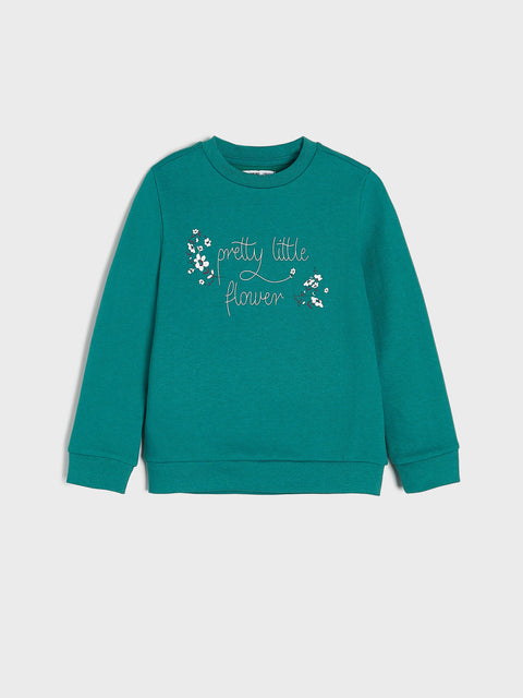 Teal sweatshirt with 'pretty little flower' text and floral design on a light gray background