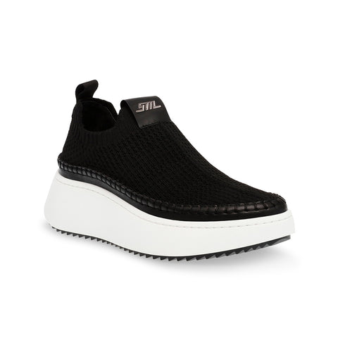 Black slip-on sneaker with white sole on a white background