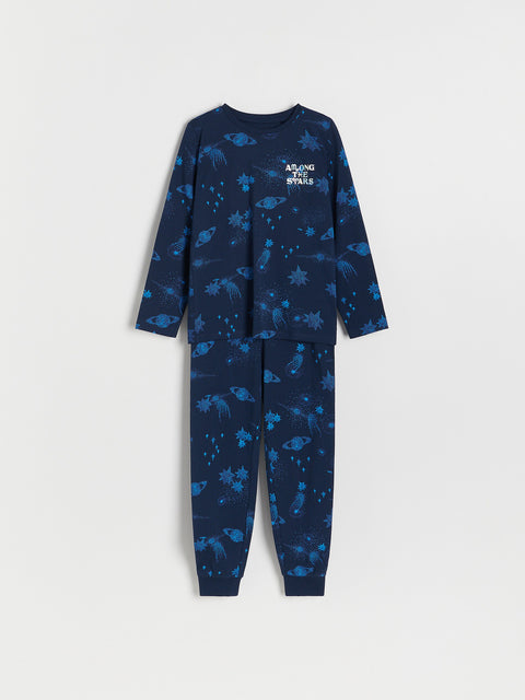 Children's navy blue pajama set with space-themed print on a white background