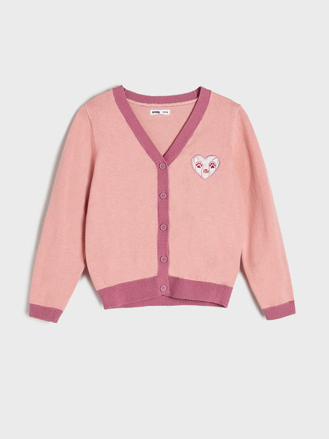 Pink cardigan with a heart design on a light gray background