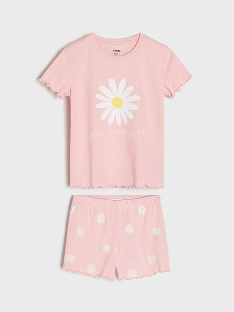 Pink pajama set with daisy design on a white background