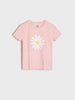 Pink t-shirt with a white daisy graphic on a light gray background
