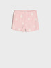 Pink shorts with daisy pattern on a white background