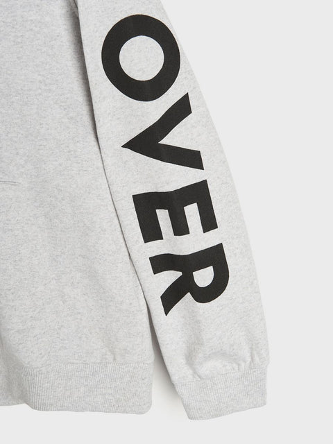 Gray sweatshirt sleeve with 'OVER' printed in black on a white background