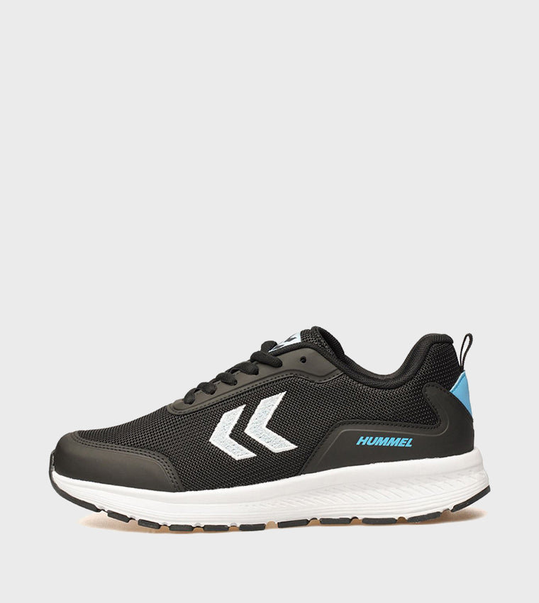 A black and white Hummel athletic sneaker with a light blue heel accent, shown from the side against a light gray background.