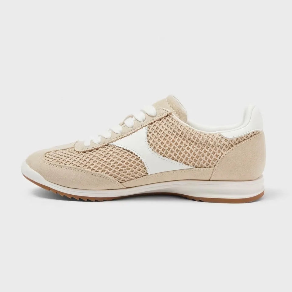 Beige sneaker with white accents on a light gray background