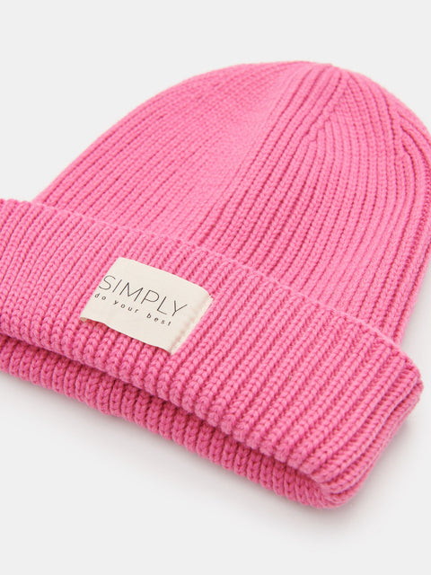 Pink beanie with a label on a white background