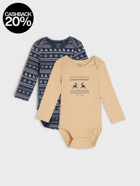 Two baby outfits on a white background, one with a blue pattern and the other beige with a deer design.