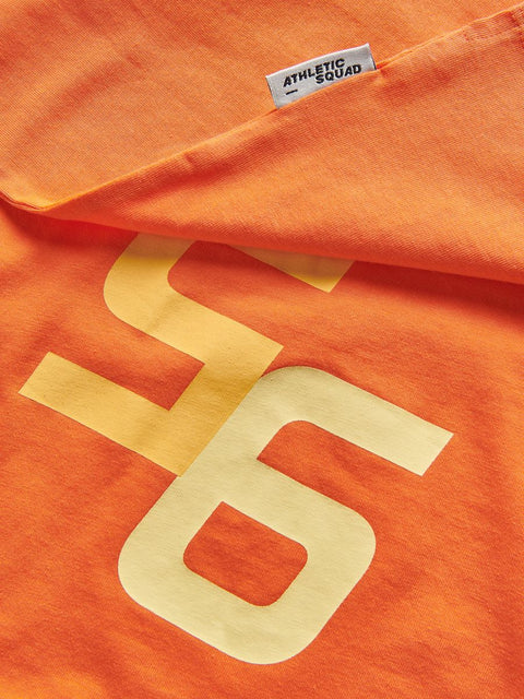 Orange t-shirt with large yellow number '6' and 'Athletic Squad' label.