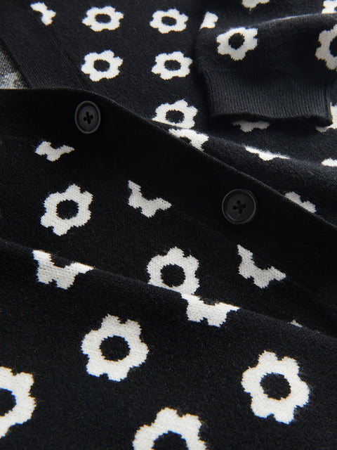 Close-up of a black garment with white floral patterns