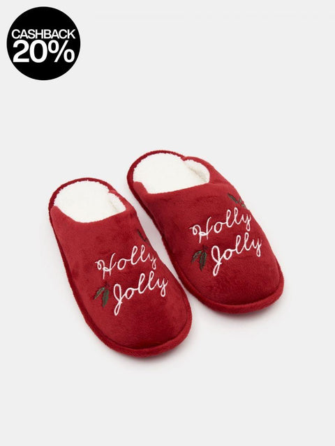 Red slippers with 'Holly Jolly' text on a white background