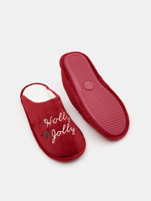 Red slippers with 'Holly Jolly' text on a white background