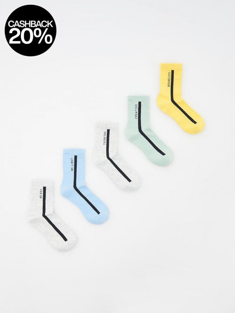 Set of four socks with geometric patterns on a white background